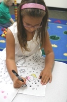 6-10 year old girl learning about the farm in Spanish class