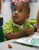 3-5 year old boy learning musical instruments in Spanish
