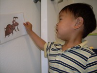2 year old boy looking at a bug visual in our Spanish Class for kids